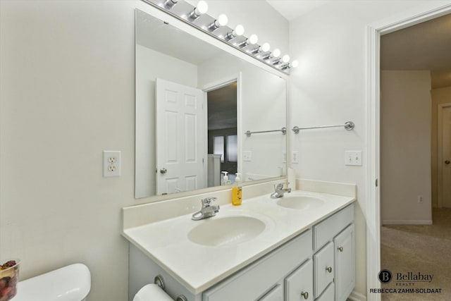 bathroom featuring vanity and toilet