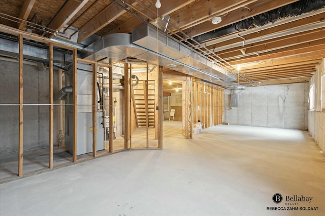 basement featuring electric panel and heating unit