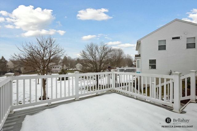 snow covered patio featuring a wooden deck