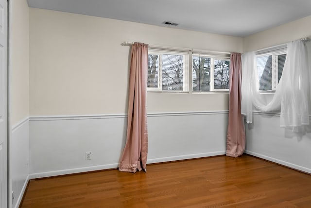 spare room featuring wood-type flooring