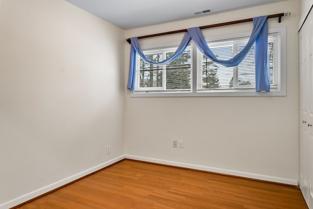 unfurnished room featuring wood-type flooring