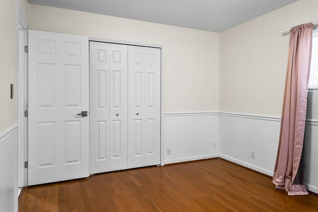 unfurnished bedroom with hardwood / wood-style floors and a closet