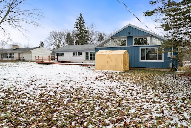 snow covered property featuring a wooden deck