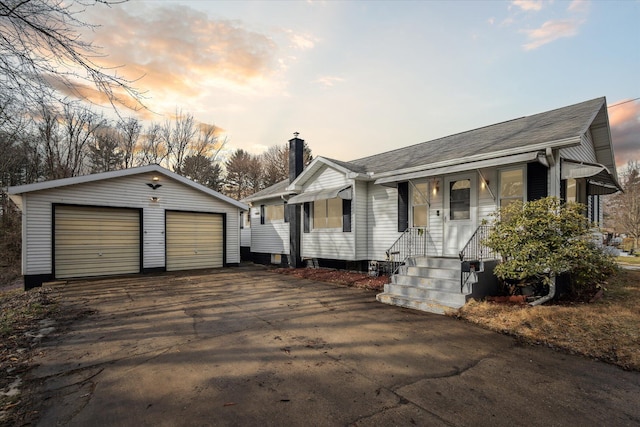 view of front facade featuring a garage and an outdoor structure