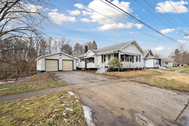 view of front of house featuring a garage and an outdoor structure