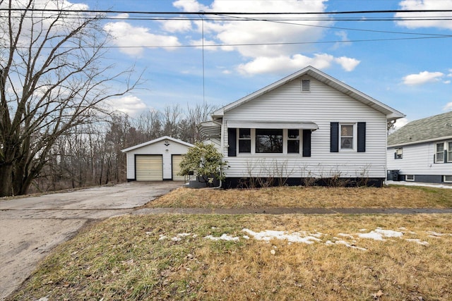 view of front of house with a garage, an outdoor structure, and a front lawn