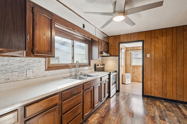 kitchen with stainless steel range with electric stovetop, sink, dark hardwood / wood-style floors, and a healthy amount of sunlight