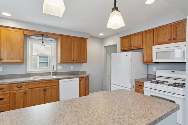 kitchen with sink, white appliances, and decorative light fixtures