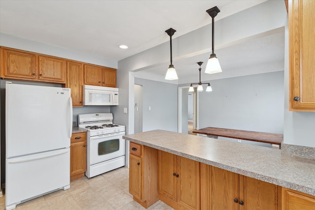 kitchen with white appliances and hanging light fixtures