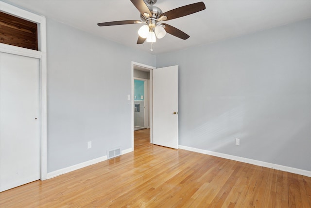 unfurnished bedroom featuring a closet, ceiling fan, and light wood-type flooring