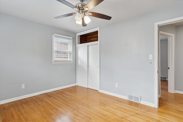 unfurnished bedroom with light hardwood / wood-style floors, a closet, and ceiling fan