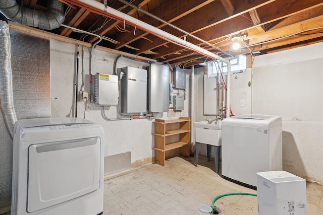 basement with sink, fridge, washing machine and dryer, and electric panel