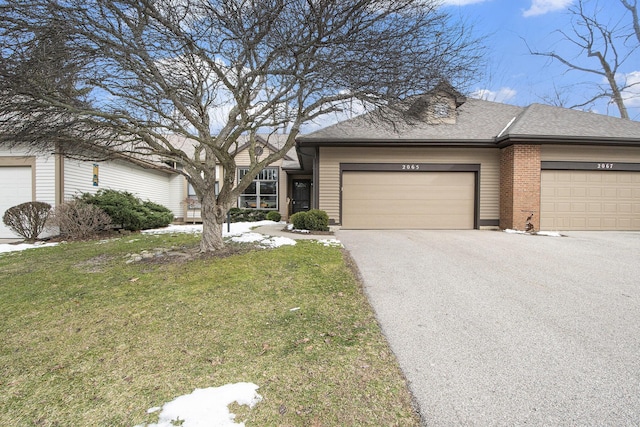 view of front of property featuring a garage and a front lawn