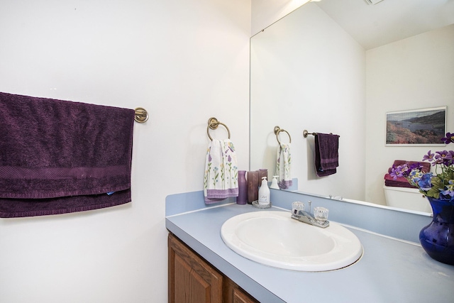 bathroom with vanity and toilet