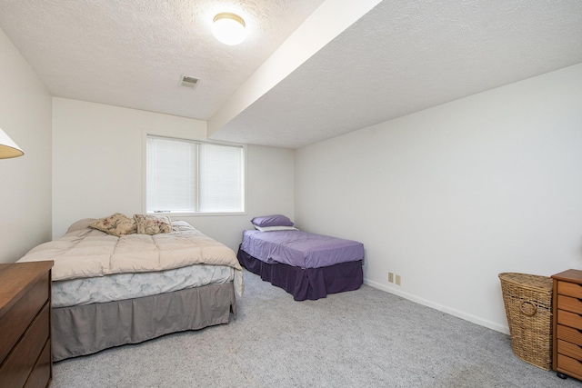 carpeted bedroom featuring a textured ceiling