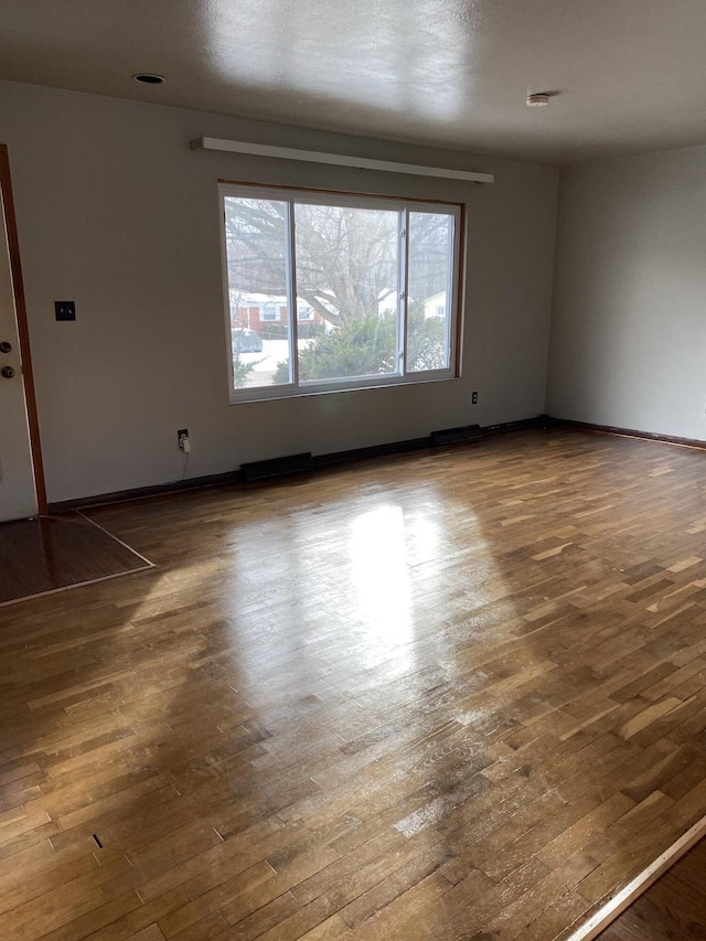 unfurnished room featuring dark hardwood / wood-style floors