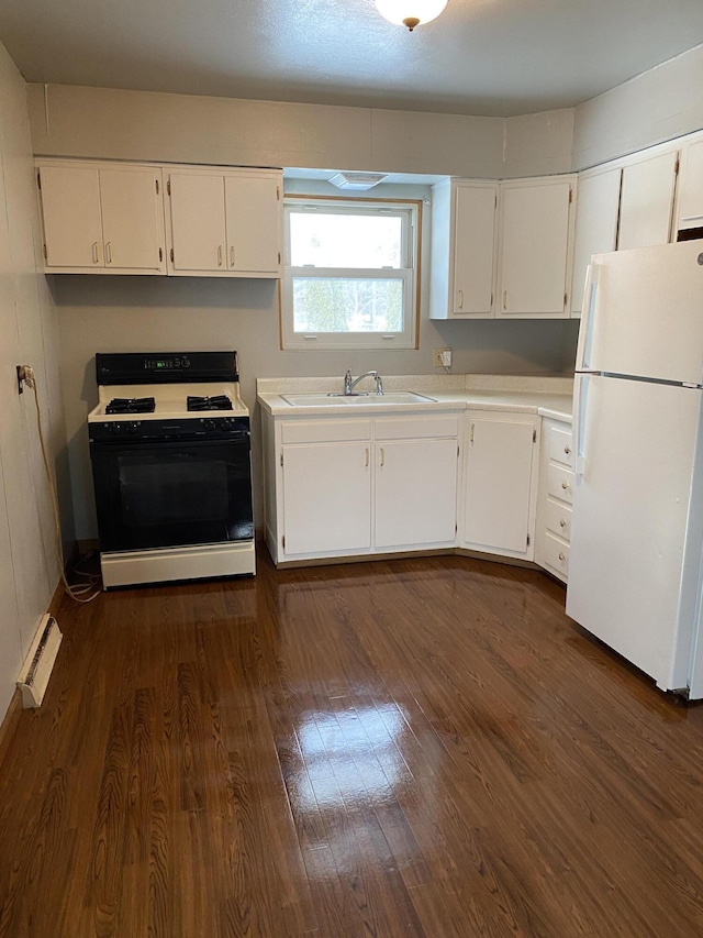 kitchen with white refrigerator, range with gas stovetop, sink, and white cabinets