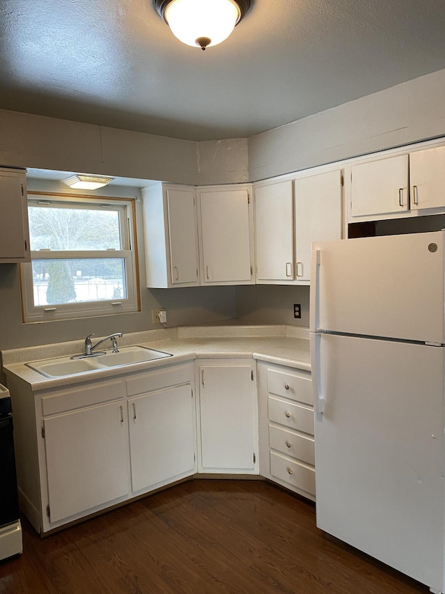 kitchen with sink, white cabinets, and white refrigerator