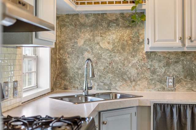 kitchen featuring tasteful backsplash, sink, and range