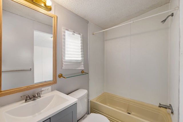 full bathroom with vanity, bathtub / shower combination, a textured ceiling, and toilet