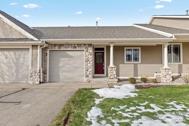 ranch-style house with a porch and a garage