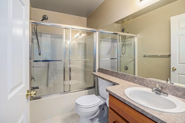 full bathroom with vanity, tile patterned flooring, enclosed tub / shower combo, and toilet