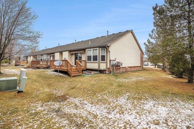 view of front of house with a wooden deck and a front yard