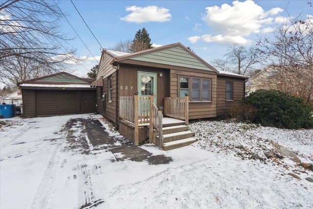 bungalow with an outbuilding and a garage