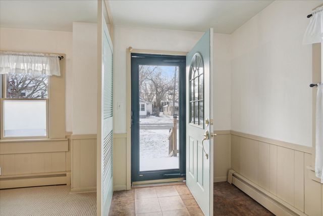 foyer entrance featuring a healthy amount of sunlight and baseboard heating