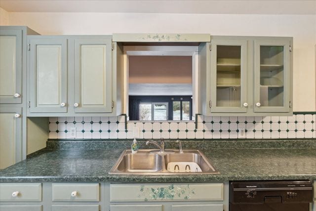 kitchen with tasteful backsplash, sink, gray cabinetry, and dishwasher