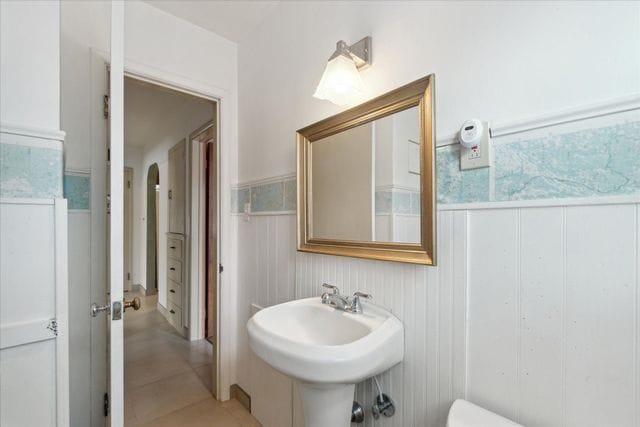 bathroom featuring sink, tile patterned floors, and toilet