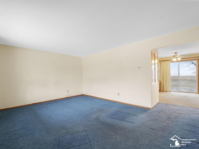 carpeted spare room featuring a textured ceiling