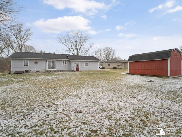 rear view of property featuring central air condition unit and a storage unit