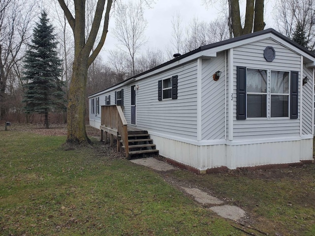 view of side of home featuring a yard