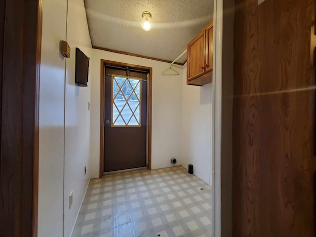 laundry area featuring crown molding and a textured ceiling