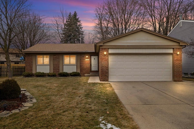 single story home with a garage and a lawn