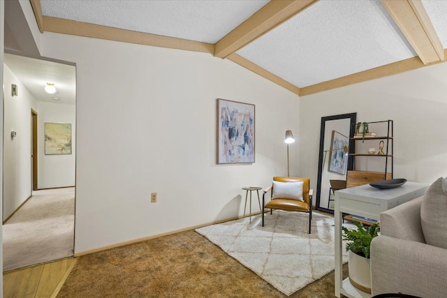 interior space featuring lofted ceiling with beams and a textured ceiling