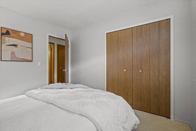 bedroom with light colored carpet and a closet