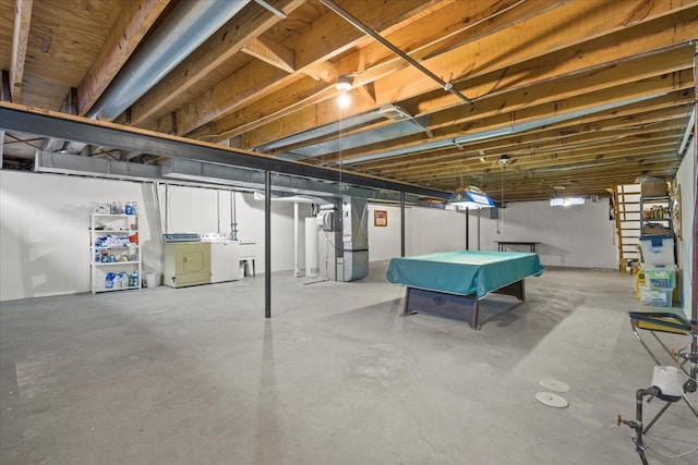 basement featuring heating unit, billiards, and independent washer and dryer