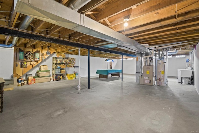 basement with heating unit, sink, and water heater