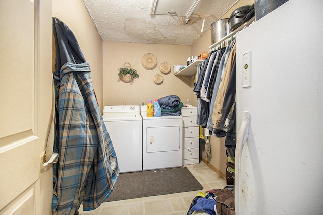 laundry area featuring washer and clothes dryer and a textured ceiling