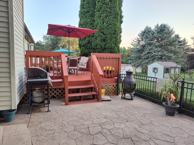 view of patio featuring a shed, area for grilling, and a deck