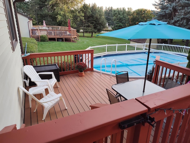 view of pool featuring a yard and a deck