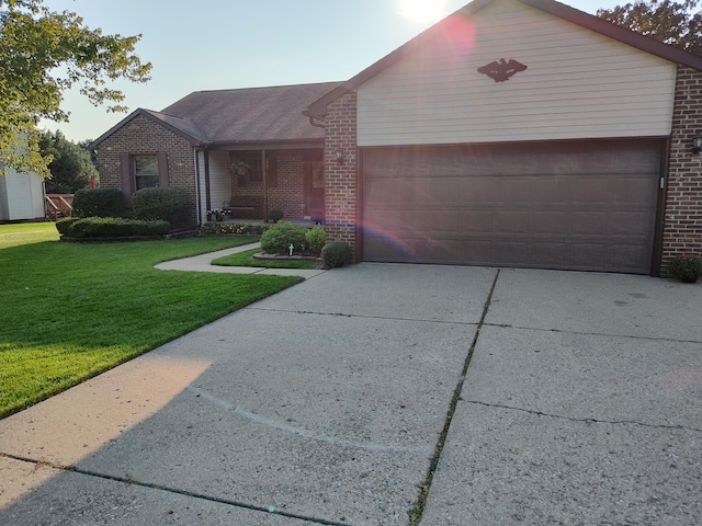 ranch-style house with a garage and a front lawn