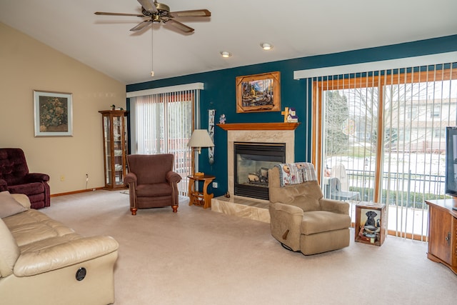 carpeted living room with a premium fireplace, vaulted ceiling, and ceiling fan