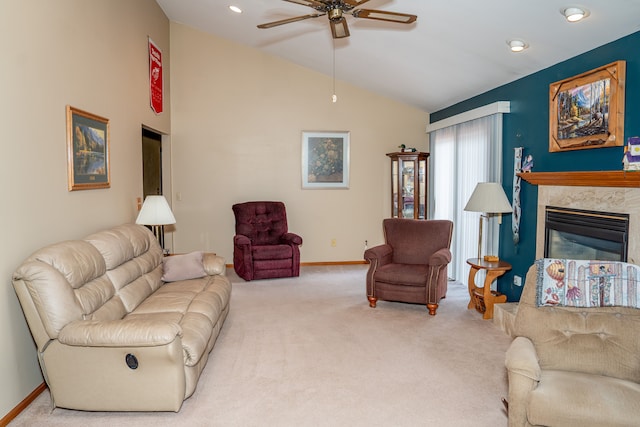 carpeted living room featuring lofted ceiling, a premium fireplace, and ceiling fan