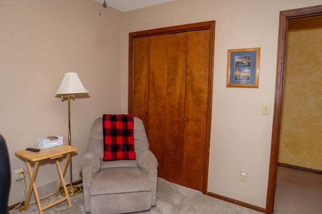 sitting room featuring light colored carpet