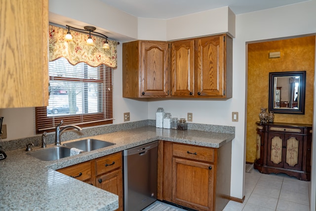 kitchen featuring sink, light stone countertops, dishwasher, and light tile patterned flooring