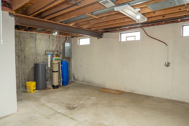 basement featuring a healthy amount of sunlight and electric panel