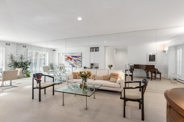 living area featuring light colored carpet, visible vents, and recessed lighting